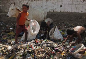 Kids picking up recyclables from trash